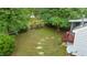 Well-maintained backyard featuring a partial fence, stepping stones and mature trees at 3405 E Jameson Rd, Raleigh, NC 27604