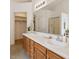 Bathroom featuring a double vanity, large mirror, and tile flooring; bright and functional at 3405 E Jameson Rd, Raleigh, NC 27604
