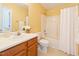 Bright bathroom featuring a vanity with white sink, toilet, and shower with a white curtain at 3405 E Jameson Rd, Raleigh, NC 27604