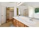 Bathroom featuring double sinks, wood cabinets, large mirror, and a shower/tub combo at 3405 E Jameson Rd, Raleigh, NC 27604