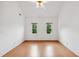 Bright bedroom showcasing light wood floors, neutral walls, and two windows at 3405 E Jameson Rd, Raleigh, NC 27604