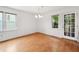 The light-filled dining room boasts hardwood floors and a glass paneled door to the backyard at 3405 E Jameson Rd, Raleigh, NC 27604