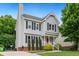Charming two-story home with gray siding, black shutters, manicured landscaping, and a red front door at 3405 E Jameson Rd, Raleigh, NC 27604