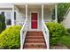 Eye-level view of the home's front steps, leading to a red front door and welcoming entrance at 3405 E Jameson Rd, Raleigh, NC 27604