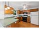 A well-lit kitchen with wood cabinets, a black oven and a white refrigerator at 3405 E Jameson Rd, Raleigh, NC 27604