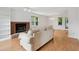 Bright living room showcases hardwood floors, a brick fireplace, and a comfortable sofa at 3405 E Jameson Rd, Raleigh, NC 27604
