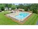 Aerial view of a community pool surrounded by lounge chairs and manicured lawn at 3405 E Jameson Rd, Raleigh, NC 27604