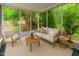 Bright sunroom with comfortable seating, neutral decor, and views of the landscaped backyard at 3405 E Jameson Rd, Raleigh, NC 27604