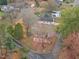 Aerial view of a home nestled among mature trees and a well-manicured lawn at 345 Henderson St, Oxford, NC 27565