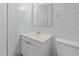 Tiled bathroom includes a simple vanity with cabinet and a standard white toilet at 345 Henderson St, Oxford, NC 27565