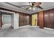Room with wood-paneled walls showcasing access to a kitchen, and a sunroom at 345 Henderson St, Oxford, NC 27565