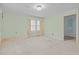 Neutral bedroom featuring soft carpet, one window with natural light, and mint-green walls at 345 Henderson St, Oxford, NC 27565