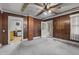 Image featuring wood-paneled bedroom with openings to other rooms, and natural light at 345 Henderson St, Oxford, NC 27565