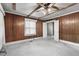 Spacious bedroom with wood-paneled walls, ceiling fan, and multiple doorways at 345 Henderson St, Oxford, NC 27565