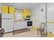 Functional kitchen with yellow cabinets, white appliances, and essential cooking space at 345 Henderson St, Oxford, NC 27565