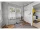 Unfinished room with wood walls, and a view into the kitchen at 345 Henderson St, Oxford, NC 27565