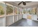 Enclosed sunroom showcasing natural light with screens, and gray painted floors at 345 Henderson St, Oxford, NC 27565