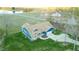 Aerial view of the home, with a long driveway and lush lawn surrounded by trees and a pond at 390 Lake Magnolia Way, Smithfield, NC 27577