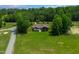 Aerial view of lake home with manicured lawn and surrounding forest at 390 Lake Magnolia Way, Smithfield, NC 27577