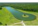 Aerial view of lake with island and boat launch at 390 Lake Magnolia Way, Smithfield, NC 27577