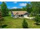 Aerial view showcasing the home's lawn, landscaping, stone accents, and two-car garage at 390 Lake Magnolia Way, Smithfield, NC 27577