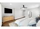 Staged bedroom featuring a ceiling fan, an ensuite bathroom, and a wood dresser at 390 Lake Magnolia Way, Smithfield, NC 27577