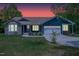 Charming single-story home featuring stone accents, a two-car garage, and a well-manicured lawn at 390 Lake Magnolia Way, Smithfield, NC 27577