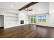 Bright, open living room with fireplace and built-ins, with view to back deck at 390 Lake Magnolia Way, Smithfield, NC 27577