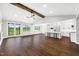 Spacious, open living area with hardwood floors and plenty of natural light connects to modern kitchen at 390 Lake Magnolia Way, Smithfield, NC 27577