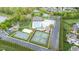 Overhead view of community with a clubhouse, pool, playground, basketball and tennis courts at 4110 Argyle Trl, Burlington, NC 27215