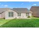 Brick home featuring windows, door, green lawn and patio at 4110 Argyle Trl, Burlington, NC 27215