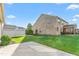 Brick home with lush green lawn, patio, and privacy fence at 4110 Argyle Trl, Burlington, NC 27215