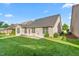 Brick home featuring green lawn, patio, and windows at 4110 Argyle Trl, Burlington, NC 27215