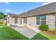 Brick home featuring windows, door, patio, and green lawn at 4110 Argyle Trl, Burlington, NC 27215