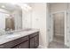 The bathroom features and sinks on the granite countertop, next to a door to the walk-in closet at 4110 Argyle Trl, Burlington, NC 27215