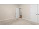 This bedroom features a doorway to another room next to a white door, with beige carpet throughout at 4110 Argyle Trl, Burlington, NC 27215