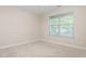 This bedroom includes a window letting in natural light, with beige carpet throughout the room at 4110 Argyle Trl, Burlington, NC 27215