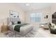 This bedroom features a beautiful bed with a gray headboard and art, next to a window letting in natural light at 4110 Argyle Trl, Burlington, NC 27215