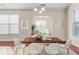 Dining room with a wooden table, seating for six, and a view into the living room at 4110 Argyle Trl, Burlington, NC 27215