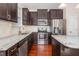 Modern kitchen featuring granite countertops, stainless steel appliances and dark cabinetry at 4110 Argyle Trl, Burlington, NC 27215