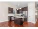 Modern kitchen featuring stainless steel appliances, dark cabinetry, and a granite island at 4110 Argyle Trl, Burlington, NC 27215