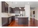 Well-equipped kitchen with stainless steel appliances and dark cabinets with a large island at 4110 Argyle Trl, Burlington, NC 27215