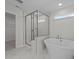 Luxurious bathroom with a freestanding tub, a walk-in shower, and a marble floor at 432 Golden Dragonfly St, Wake Forest, NC 27587