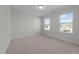 Bright bedroom featuring neutral carpet, two windows and natural light at 432 Golden Dragonfly St, Wake Forest, NC 27587