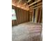 New construction showing a bedroom area with exposed framing and a window to allow in natural light at 432 Golden Dragonfly St, Wake Forest, NC 27587