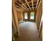 An unfinished bedroom has exposed wooden beams, wiring, framing, and shows two windows for natural light at 432 Golden Dragonfly St, Wake Forest, NC 27587