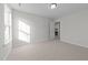 Bedroom featuring neutral carpet and light filled windows with walk-in closet access at 432 Golden Dragonfly St, Wake Forest, NC 27587