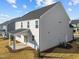 The back of this two story home has gray siding and a covered patio at 432 Golden Dragonfly St, Wake Forest, NC 27587