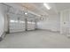 This two car garage has a concrete floor and white door at 432 Golden Dragonfly St, Wake Forest, NC 27587