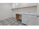 Convenient laundry room with a sink, storage cabinets, and patterned flooring at 432 Golden Dragonfly St, Wake Forest, NC 27587